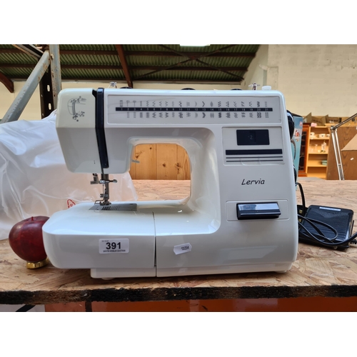 391 - A high quality Lervia sewing machine, in excellent condition complete with over and foot pedal. RRP ... 