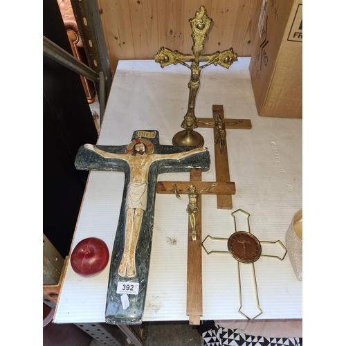 392 - A lot of five ecclesiastical crucifix's including one large wooden example.