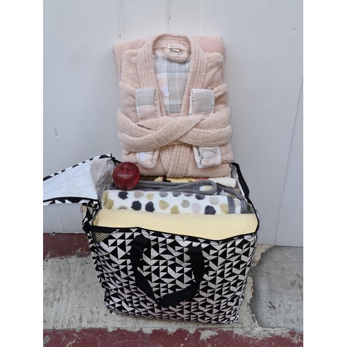 399 - A bag of mixed clothes and fabrics all in new or super condition including a new Barbour dressing go... 