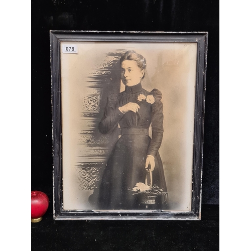 78 - A print of a elegant Victorian Lady. Housed in a black frame behind glass.