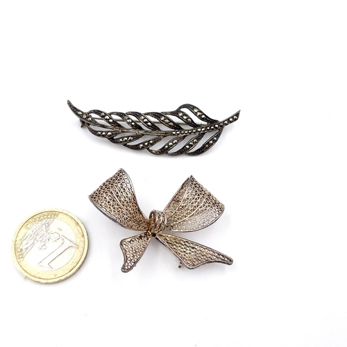 413 - An attractive pair of sterling silver vintage brooches. One set with marcasite detailing, both pins ... 