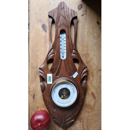 692 - Carved wooden barometer and thermometer with intricate designs, by Bergmann & Mahland, Mannheim.