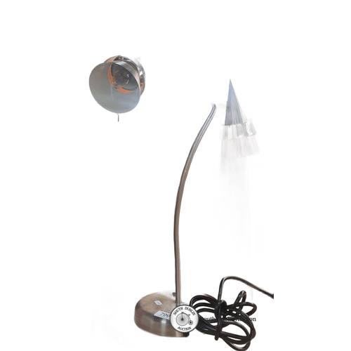 700 - Modern stainless steel dual-head desk lamp features a minimalist design with adjustable cones for fo... 