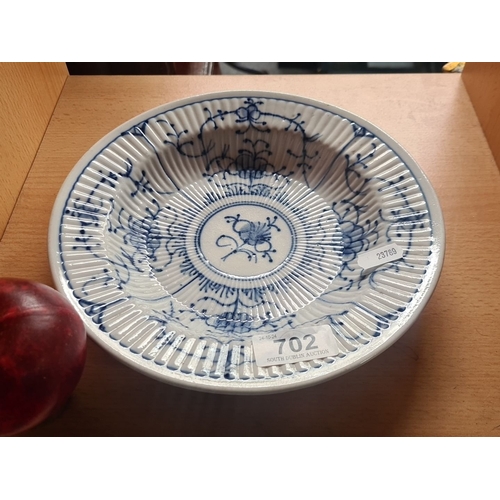 702 - An antique early Chinese Porcelain bowl with blue floral motifs, featuring ribbed detailing. Undersi... 