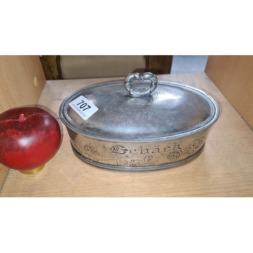 707 - Oval pewter biscuit tin dates 1774 with heart-shaped knob. Engraved 