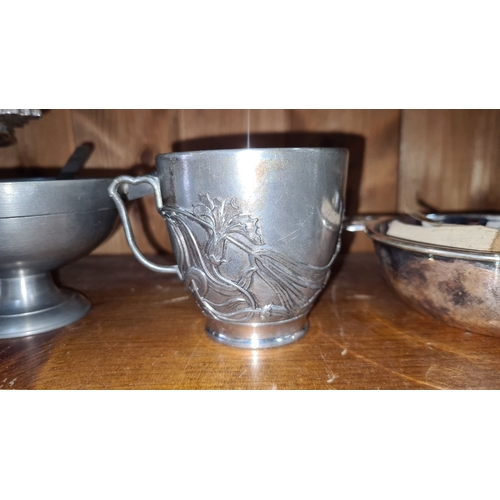 710 - A Shelf of five silver-plated pieces, featuring Art Nouveau-style cup with floral motifs, an unusual... 