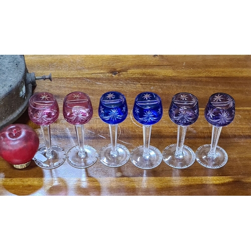 716 - Set of six cut crystal stemware glasses in rich pink and blue hues, featuring intricate starburst pa... 