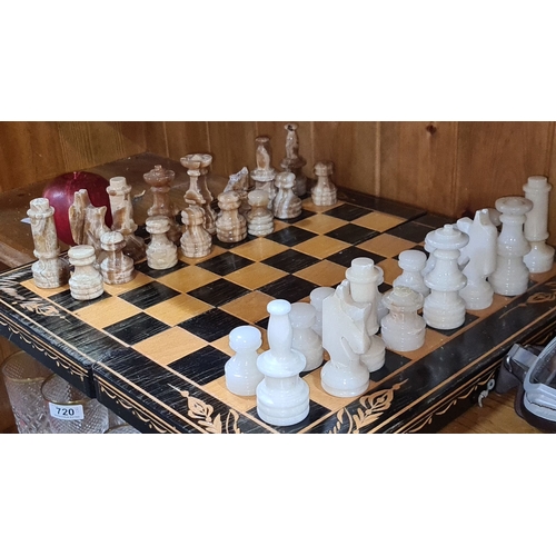 718 - A super complete marble  chess set with pieces in contrasting brown and white hues. Wooden board wit... 