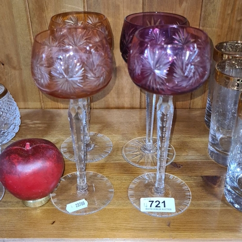 721 - Set of four cut glass goblets with intricately etched starburst design in varying shades of pink and... 