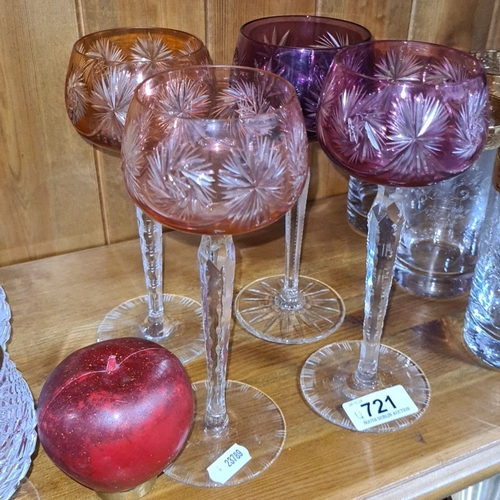 721 - Set of four cut glass goblets with intricately etched starburst design in varying shades of pink and... 