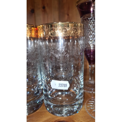 722 - Set of six heavy etched glass tumblers with ornate gold rims, featuring intricate scrolling patterns... 