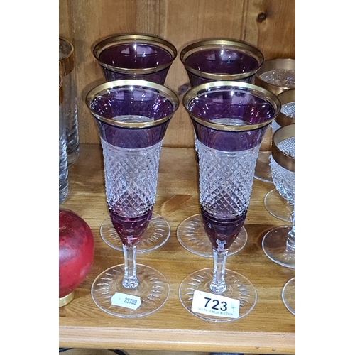 723 - Set of four amethyst and clear cut glass champagne flutes with gold rim detailing. heavy very good q... 