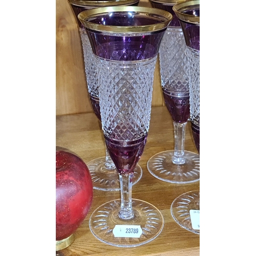 723 - Set of four amethyst and clear cut glass champagne flutes with gold rim detailing. heavy very good q... 