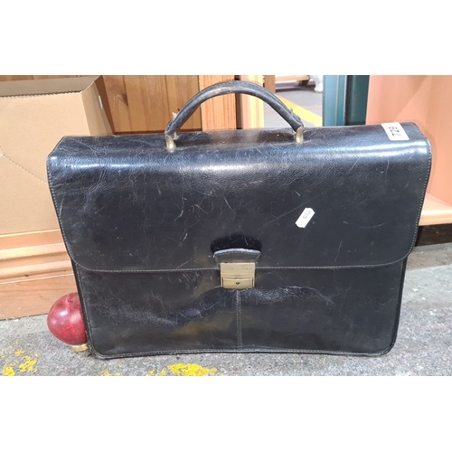 729 - Vintage leather briefcase with brass hardware, featuring multiple compartments for organization. Cla... 