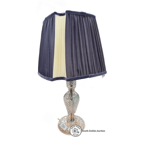 733 - A Large Crystal table lamp with an elegantly pleated fabric shade and a cut glass base.