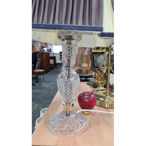 733 - A Large Crystal table lamp with an elegantly pleated fabric shade and a cut glass base.