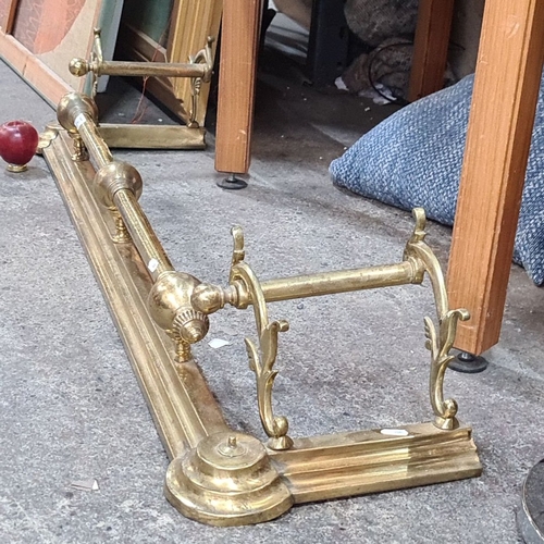 737 - Victorian brass fire fender with ornate scrollwork and polished finish, featuring turned finials and... 