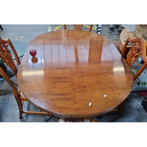 742 - Star lot : A handsome Mahogany dining table with four matching chairs features intricate chair back ... 