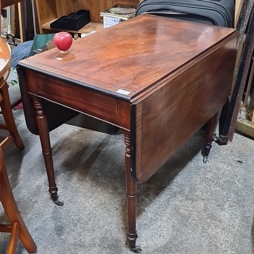 743 - Victorian mahogany drop-leaf table with turned legs and casters. Expandable for additional surface s... 