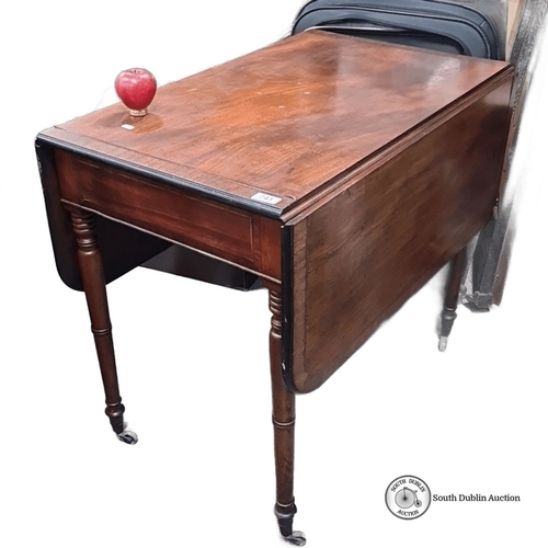 743 - Victorian mahogany drop-leaf table with turned legs and casters. Expandable for additional surface s... 