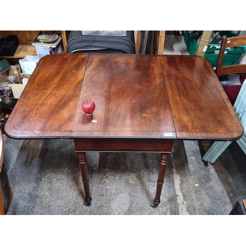 743 - Victorian mahogany drop-leaf table with turned legs and casters. Expandable for additional surface s... 