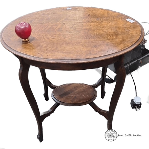 748 - Round oak occasional table with cabriole legs and lower shelf, featuring a warm patina, from the ear... 