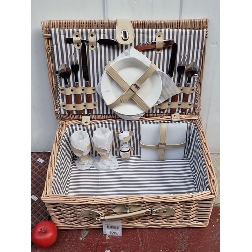 578 - Wicker picnic basket set with integrated cutlery, plates, and glasses in a striped interior. Feature... 