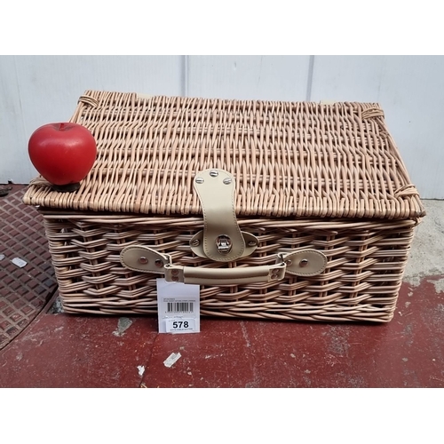 578 - Wicker picnic basket set with integrated cutlery, plates, and glasses in a striped interior. Feature... 