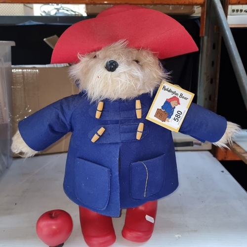 580 - Paddington Bear plush wears a blue coat and red hat, complete with original tags, referencing 