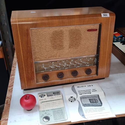 582 - A large PYE Model 48A vintage radio, wood casing with original operating pamphlets. From the 20th ce... 