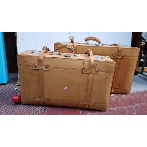 586 - Pair of vintage leather suitcases with metal hardware and black interior lining. Very clean interior... 