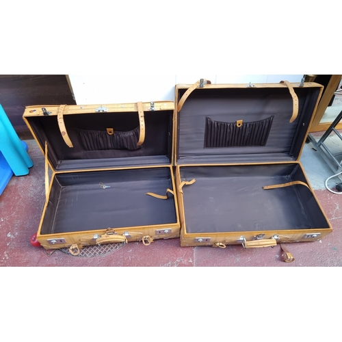 586 - Pair of vintage leather suitcases with metal hardware and black interior lining. Very clean interior... 