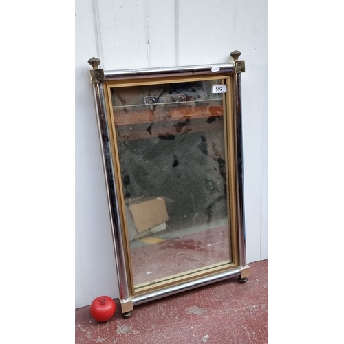 592 - Rectangular wall mirror with brass and chrome tubular frame, featuring acorn finials. Back secured w... 