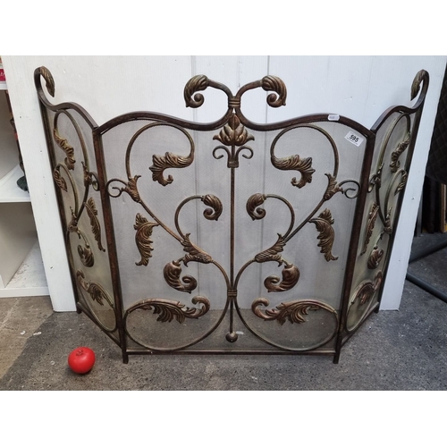 595 - A very attractive Ornate wrought iron fire screen with decorative scrollwork design, featuring three...