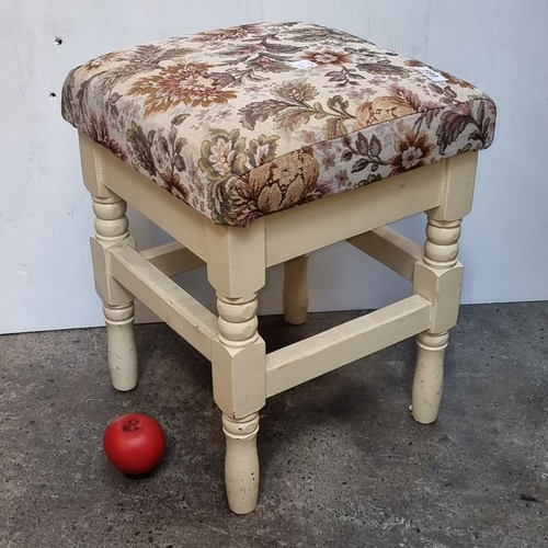 599 - Vintage upholstered stool featuring ornate floral tapestry seat and cream painted wooden legs.