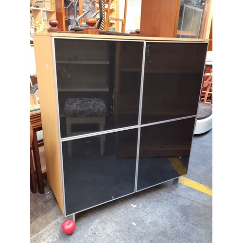 610 - Modern wooden cabinet with black glass doors 4 interior cubbies holes  from the GX Collection on ele... 