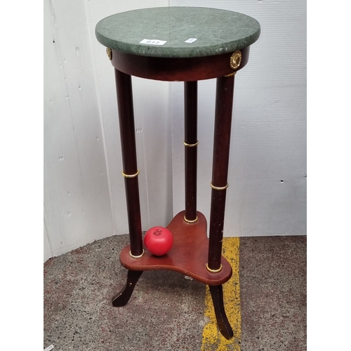 613 - Antique marble-top plant stand with mahogany base and gilt brass accents from the early 20th century... 