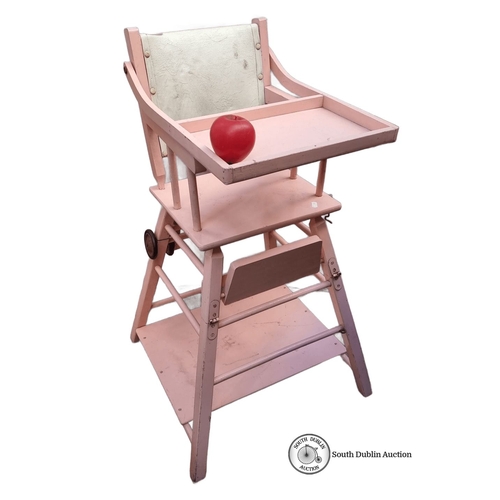 614 - Adjustable pink wooden baby high chair with tray, convertible to a play desk. Features sturdy constr... 