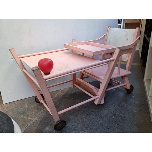 614 - Adjustable pink wooden baby high chair with tray, convertible to a play desk. Features sturdy constr... 