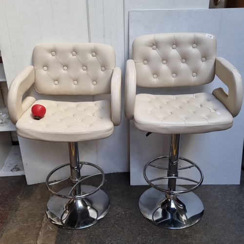 616 - Pair of contemporary tall bar stools with tufted cream upholstery and chrome swivel bases. Modern de... 