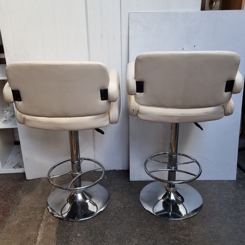 616 - Pair of contemporary tall bar stools with tufted cream upholstery and chrome swivel bases. Modern de... 