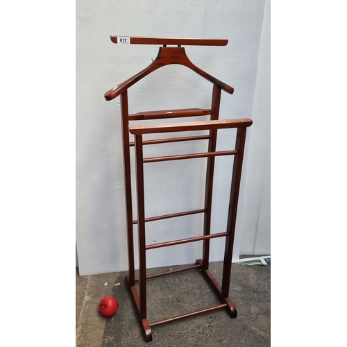 617 - Mahogany valet stand, mid-century modern style, features a hanger and tiered racks.