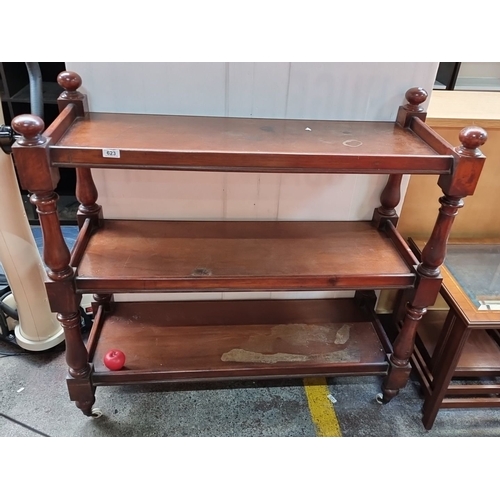 623 - Three-tier antique mahogany dumb waiter  with turned legs and casters. Victorian period design.