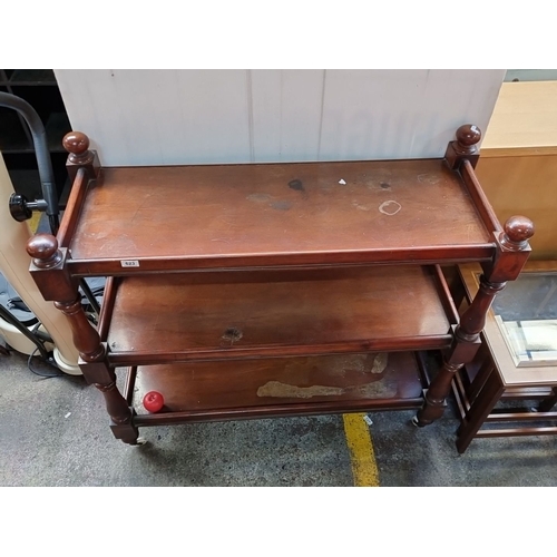 623 - Three-tier antique mahogany dumb waiter  with turned legs and casters. Victorian period design.