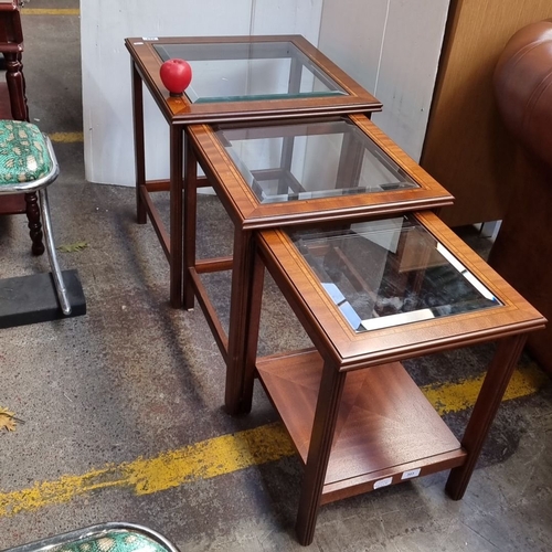 624 - Set of three nesting tables with glass tops and mahogany frames, featuring a classic Mid-Century Mod... 