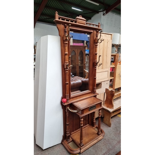 625 - Star Lot An Edwardian mahogany hall stand with mirror and integrated hooks, features intricate turne... 