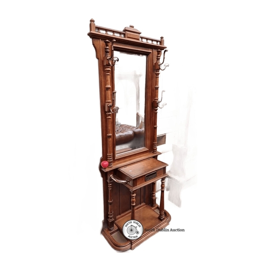 625 - Star Lot An Edwardian mahogany hall stand with mirror and integrated hooks, features intricate turne... 