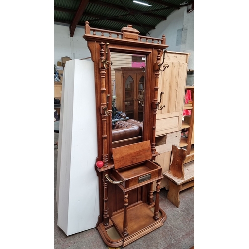 625 - Star Lot An Edwardian mahogany hall stand with mirror and integrated hooks, features intricate turne... 