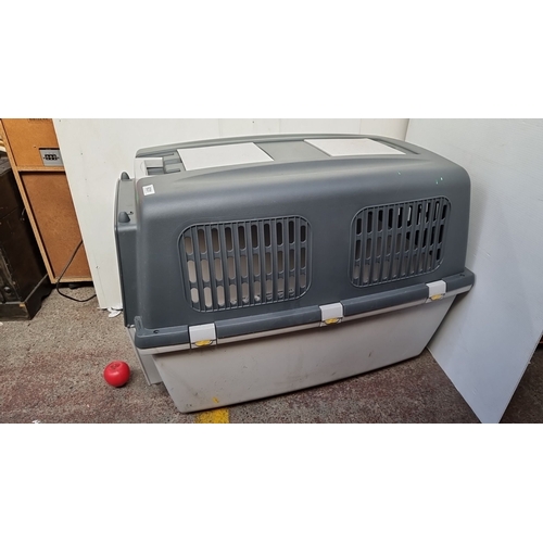 631 - A large Plastic pet crate with attachment latches, features a gray and white design labeled . Includ... 