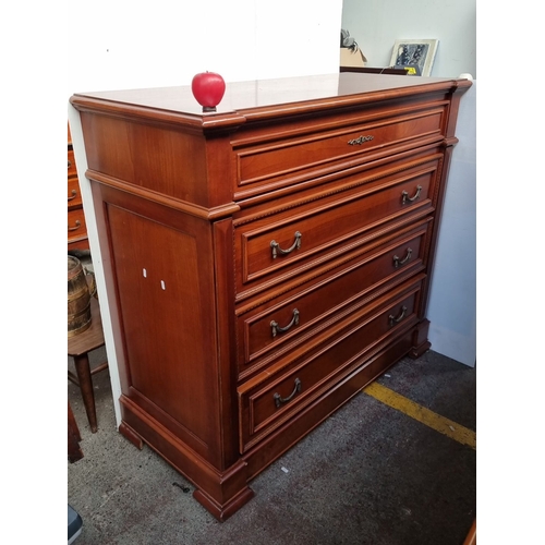 632 - A handsome red Mahogany chest of drawers with brass handles and detailed carvings.